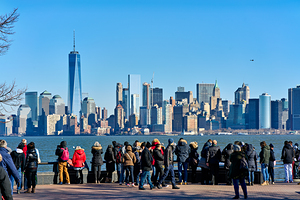 Tourists look at Manhattan skyline from Liberty Island in New Yo