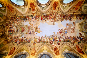 Elaborate ceiling fresco with a banquet scene and angels.