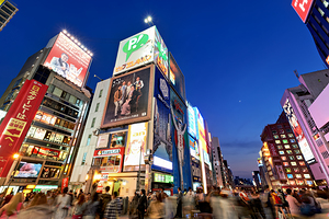 Dotonbori District in Osaka shows bright signs at sunset time