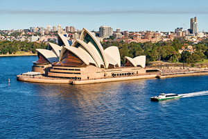 Sydney Opera House and harbor with ferry boat.
