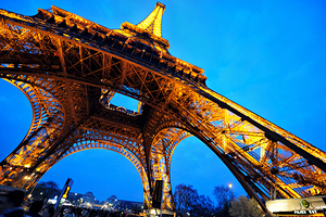 Eiffel Tower stands bright against darkening sky in Paris