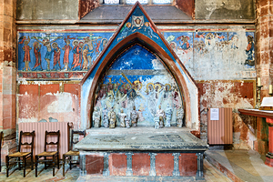 Old wall art and stone altar inside Saint Pierre le Jeune church