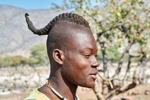 Young man with traditional hair headdress in Himba Village in Na