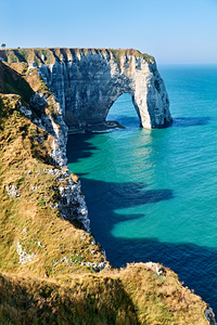Chalk cliffs of Etretat under a clear sky in Normandy France