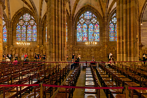 Visitors explore stained glass in Strasbourg Cathedral