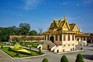 Golden roofed Cambodian palace manicured gardens and clear blu
