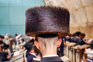 Jewish men study in Jerusalem at the Western Wall