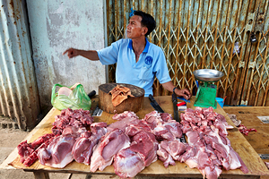 Local butcher selling meat in Phu Quoc market area