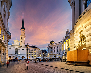 Beautiful sunset over historic Michaelerplatz Vienna with hors