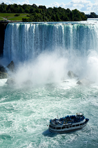 Maid of the Mist boat with tourists at Niagara Falls.