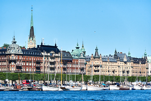View of downtown Stockholm from the sea with boats and buildings by Marco Brivio
