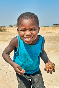 Joyful boy in Kavango Region of Namibia enjoys a moment outside