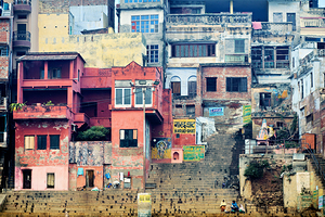 Visitors walk along the ghat by the Ganges river in Varanasi In by Marco Brivio
