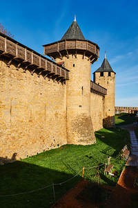 Tourists walk along the stone walls of Carcassonne