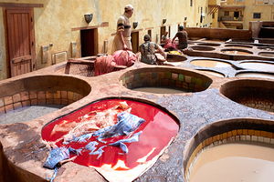 Workers dyeing leather at Chouara Tannery in Fez Morocco
