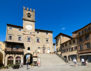 Visitors walk in Piazza della Repubblica near Palazzo del Popolo