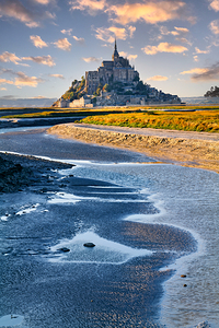 Mont Saint Michel stands tall in Normandy as dusk sets in