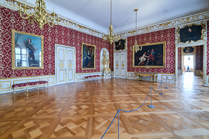 Visitors explore the large rooms of Residenz Palace in Munich