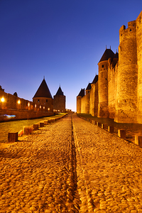 Explore the ancient walls of Carcassonne at dusk