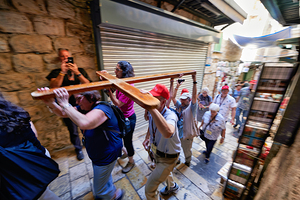 Pilgrims walk along the Way of Sorrows in Jerusalem Israel