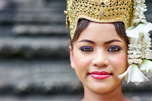 Close up of woman in traditional golden crown and white flowers.