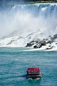 Hornblower boat with tourists approaching Niagara Falls. by Marco Brivio