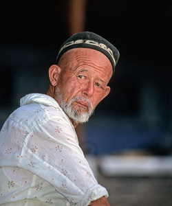 Man in traditional attire sitting in Bukhara Uzbekistan