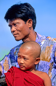 Portrait of a father and son in Myanmar during the day by Marco Brivio