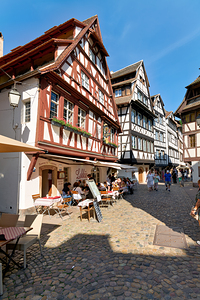 Colorful timber houses in Petit France with food loving visitors