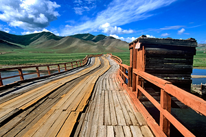 Bridge in Mongolia connects land over open fields and water by Marco Brivio