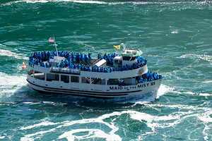 Maid of the Mist boat carrying tourists through water.