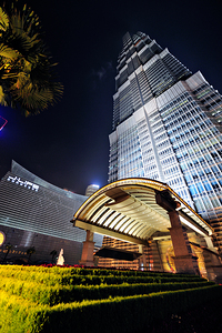 Modern skyscraper with bright entrance at night in Shanghai