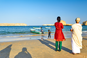 Locals watch boats at Muscat Oman beach in the daytime