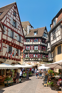 Timber framed houses in old town of Colmar with market stalls by Marco Brivio
