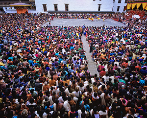 Large crowd watches traditional dance performance at outdoor fes