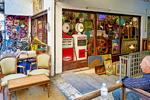 Flea market scene in Monastiraki Athens with shops and visitor