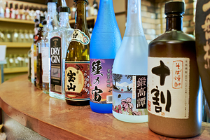 Sake bottles displayed on a counter in Kyoto Japan