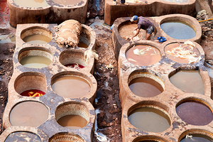 Workers processing leather at Chouara Tannery in Fez Morocco