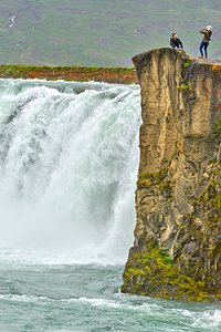 People standing near Godafoss waterfall in Iceland