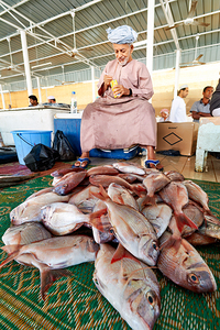 Man sells fresh fish at Muscat Oman fish market today