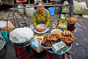 Woman selling food at street market in Ho Chi Minh City