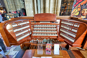 Intricate wooden pipe organ console with multiple keyboards and 
