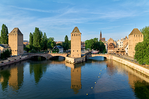 Covered bridges connect towers over water in Strasbourg Alsace