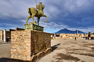 Exploring the ruins of Pompeii with Mount Vesuvius in the backgr