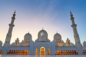 Illuminated Sheikh Zayed Grand Mosque during dusk in Abu Dhabi