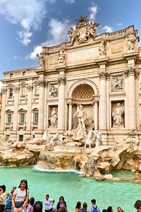 Tourists gather at Trevi Fountain in Rome during a sunny day