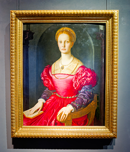 Lucrezia Panciatichi sits in a chair holding a book