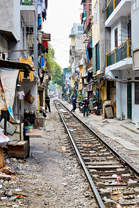 People walk along railway tracks in Ho Chi Minh City Vietnam