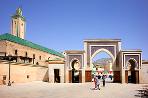 Visitors walk through Bab Rcif gate in Fez Morocco during the d