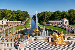 People walk and admire the fountains at Peterhof Palace in St by Marco Brivio